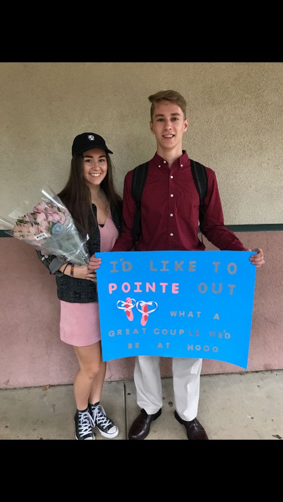 two people standing next to each other holding flowers and a sign that says pointe out