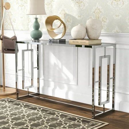 a modern console table with two stools and a lamp on the floor next to it