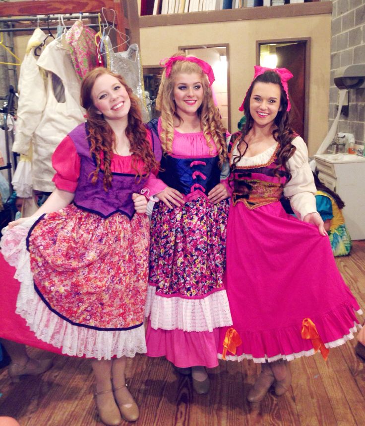 three women dressed in costume posing for the camera