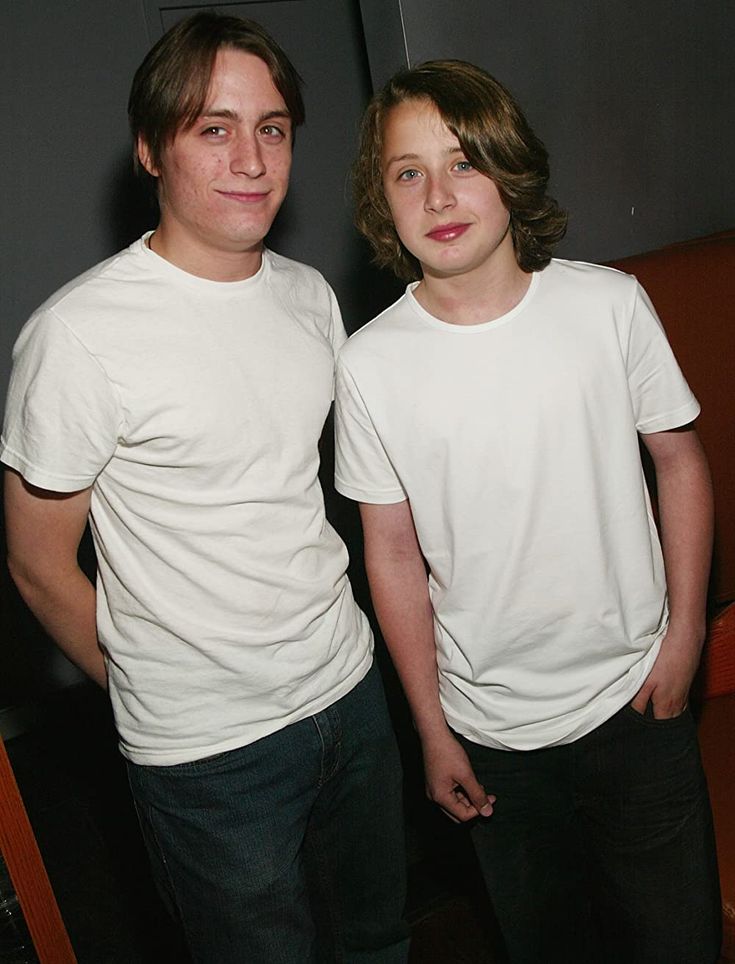 two young men standing next to each other