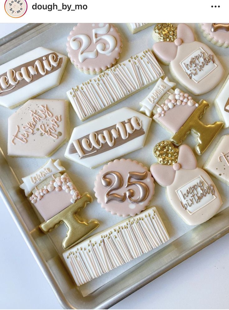 decorated cookies in the shape of cakes and numbers on a cookie sheet with gold trimmings