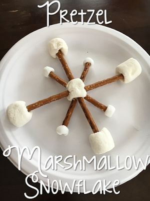 marshmallow snowflake pretzel treats on a white plate with the title overlay