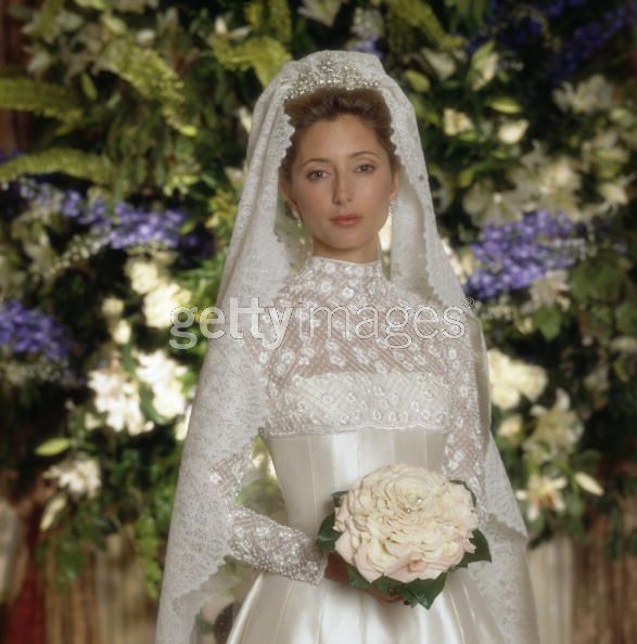 a woman in a wedding dress holding a bouquet