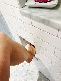 a man is taking a selfie in the bathroom mirror with his cell phone and toilet paper