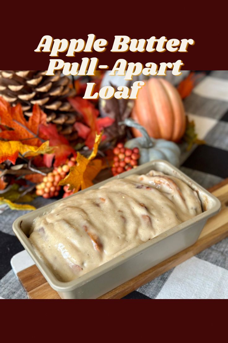 an apple butter pull - apart loaf in a pan on a table with fall leaves