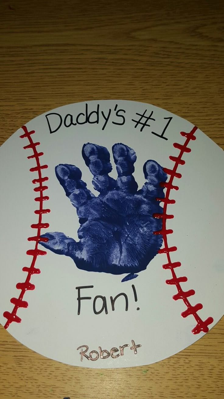 a baseball with a handprint on it that says, daddy's 1 fan