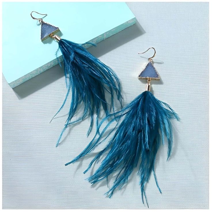 Elevate your style with these exquisite Women's Ostrich Feather Earrings. Crafted with attention to detail, these earrings feature delicate ostrich feathers that add a touch of elegance and sophistication to any outfit. The lightweight design ensures comfortable wear throughout the day, while the vibrant colors of the feathers create a stunning visual impact. Whether you're attending a special event or simply want to make a statement, these earrings are the perfect accessory to enhance your look Elegant Adjustable Feather Earrings, Elegant Feather Earrings, Elegant Blue Feather Earrings, Feather Earrings For Summer, Summer Party Earrings With Feathers, Feather Party Jewelry For Summer, Copper Style, Ostrich Feather, Earring For Women