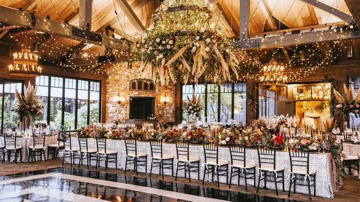 an indoor venue with tables, chairs and chandeliers