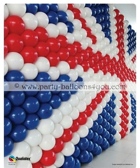 red, white and blue balloons are lined up against the wall