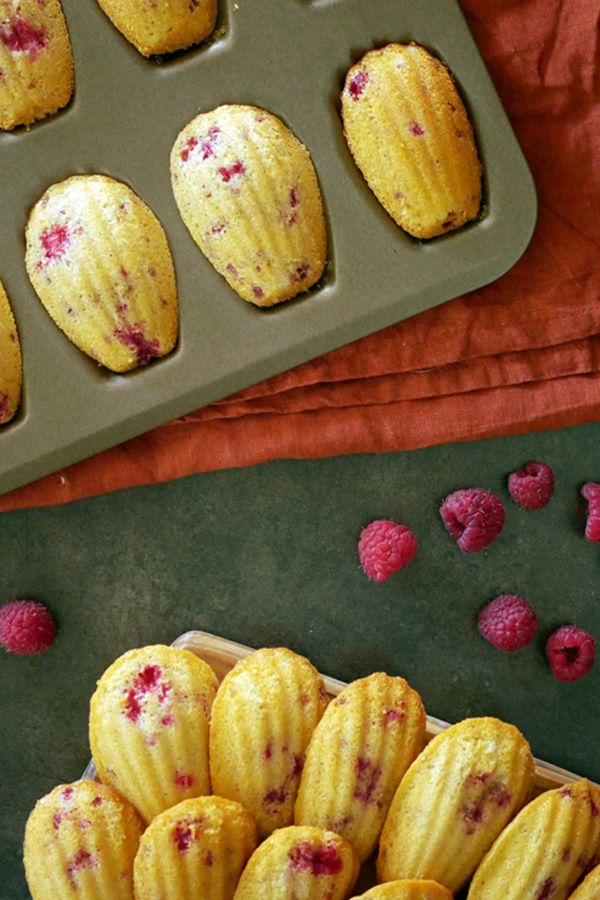 raspberry filled muffins in a pan and on a table