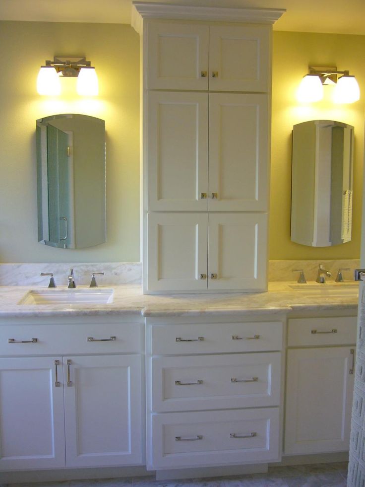 a bathroom with double sinks and two mirrors