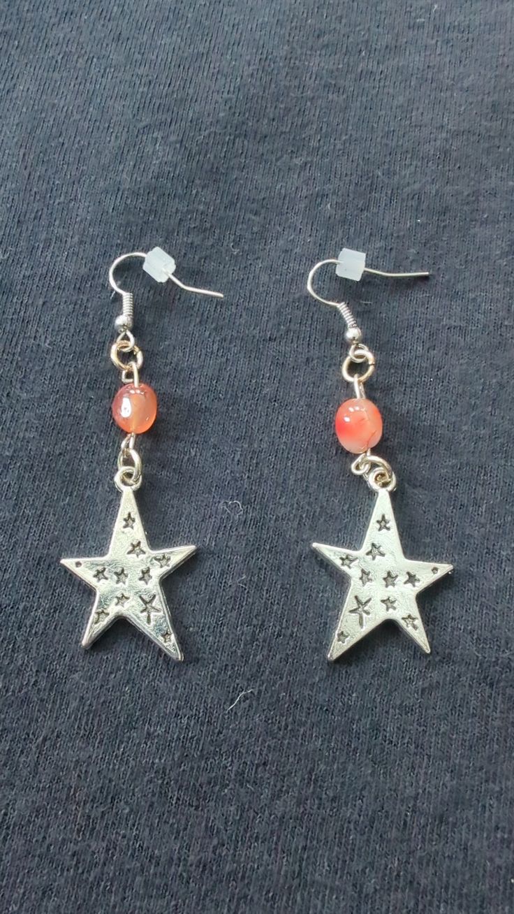 Earrings with red carnelian beads and silver star charms Red Star-shaped Beaded Jewelry, Red Star Charm Earrings, Red Star-shaped Earrings With Star Charm, Nickel-free Red Carnelian Earrings, Silver Star-shaped Beaded Earrings, Red Star Charm Earrings For Gift, Nickel-free Red Star Earrings, Red Star-shaped Nickel-free Earrings, Red Carnelian