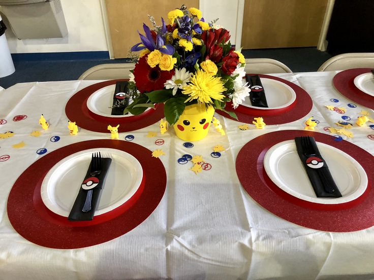 the table is set with plates and flowers