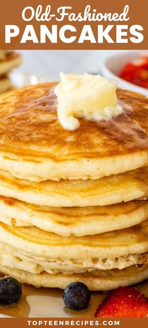 stack of pancakes with butter on top and blueberries in the foreground text overlay reads, old - fashioned pancakes