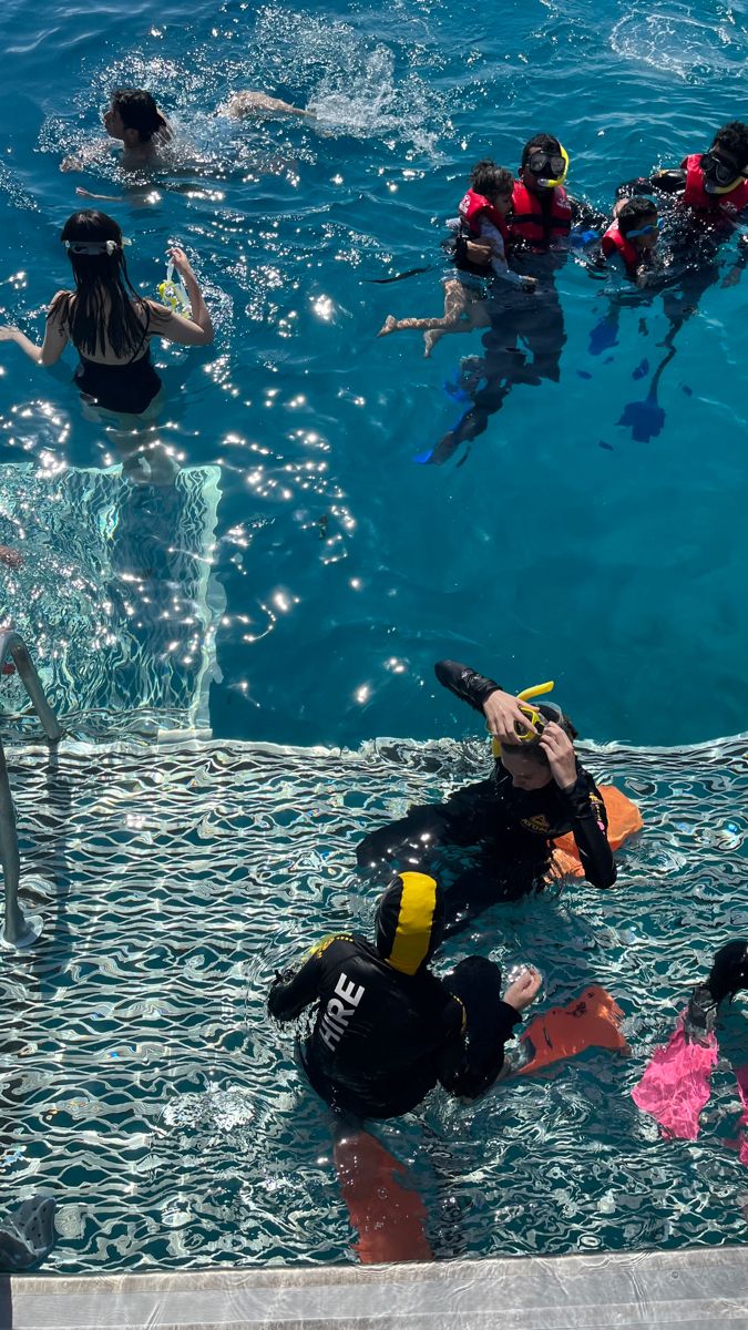 several people in the water with scuba gear