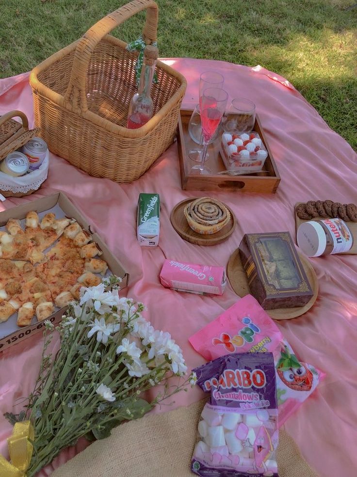 a picnic table with food and snacks on it