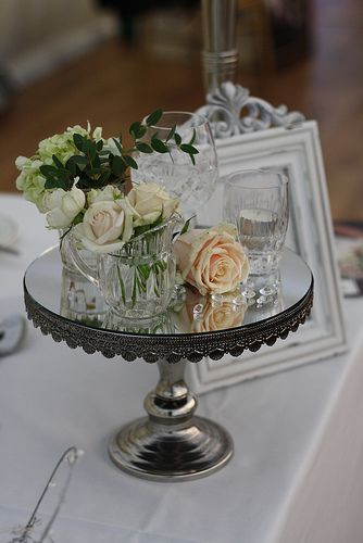 there is a glass cake plate with flowers on it