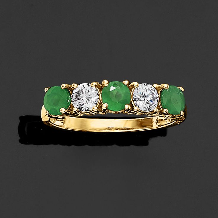 an emerald and diamond five stone ring