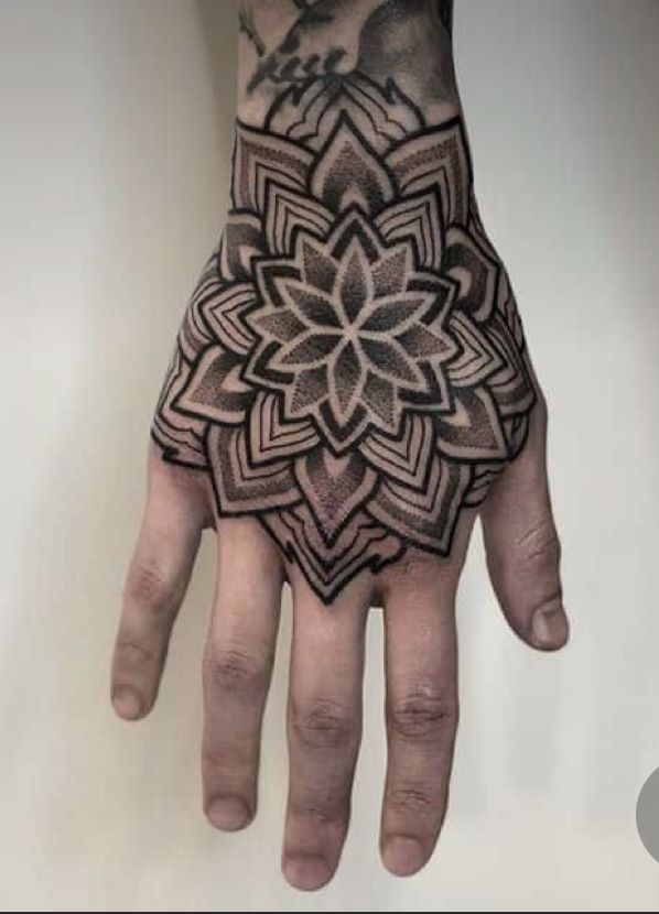 a person's hand with a tattoo on it