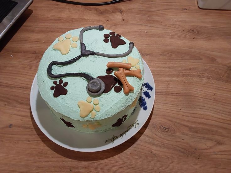 a cake decorated with dog paw prints and a stethoscope on the top