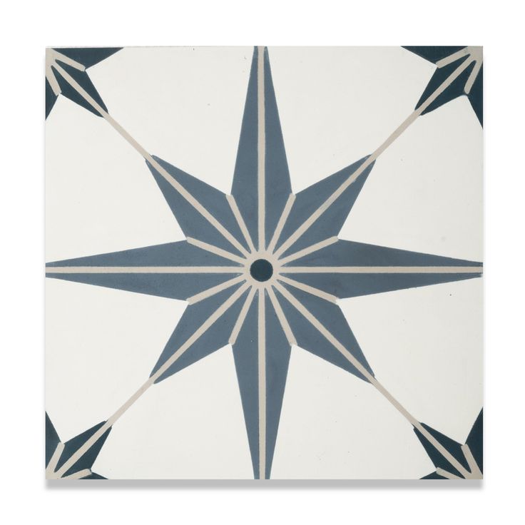 a white and blue tile with an intricate star design on the bottom half of it