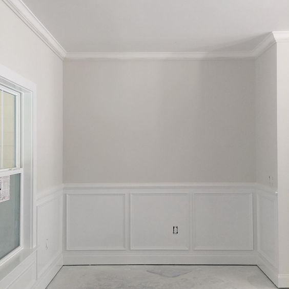 an empty room with white walls and no one in the room or there is a window