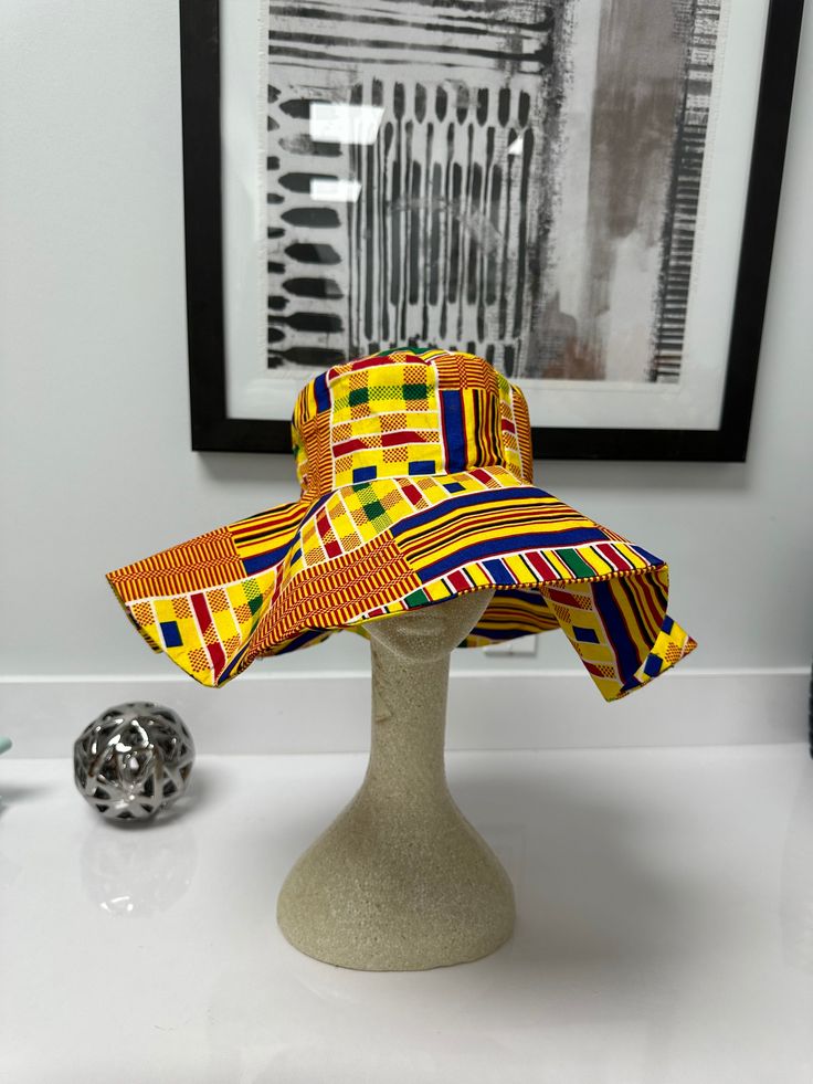 Enjoy our over sized African print sun hat this summer!! Hat with its wide range brim makes it very useful as a beach hat without compromising on fashion! Your Ankara hat is not too big or too small; Just the right statement piece! Not crazy about the beach? Wear it to your cookouts or fun garden party or outdoor festivals with your favorite solid colored outfits. *Hats will arrive folded and can be ironed to take any creases out or wear it just the way it falls with folds. *Lighting may alter c Fun Wide Brim Bucket Hat For Summer, Fun Wide Brim Hats With Uv Protection, Fun Short Brim Sun Hat For Vacation, Fun Adjustable Wide Brim Bucket Hat, Trendy Multicolor Sun Hat For Beach, Multicolor Summer Bucket Hat With Upf 50+, Multicolor Short Brim Hat With Upf 50+, Fun Curved Brim Sun Hat For Vacation, Adjustable Fun Style Sun Hat