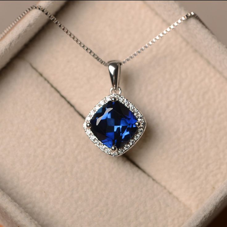 This halo necklace features a 9*9mm cushion cut lab sapphire and sterling silver finished with rhodium. Customization is available. It is made by hand, and it will take about 7 days to finish the ring after your payment is completed. Main stone: Lab sapphire Sapphire weight: Approx 2.75 ct Metal type: sterling silver finished with rhodium Accent stone: cz If select 14k gold option,only the pendantNot included the Chain Customization is available, I also can make it with 14k solid gold (white or Blue Sapphire Diamond Pendant, Custom Birthstone Ring, Sapphire Diamond Pendant, Blue Sapphire Pendant, Sapphire Necklace Pendants, Blue Sapphire Necklace, Halo Necklace, Tanzanite Diamond, Blue Sapphire Diamond