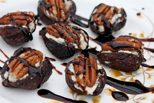 chocolate desserts with pecans and caramel drizzled on top are sitting on a white plate