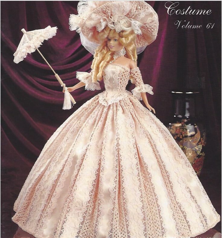 a barbie doll wearing a pink dress and hat