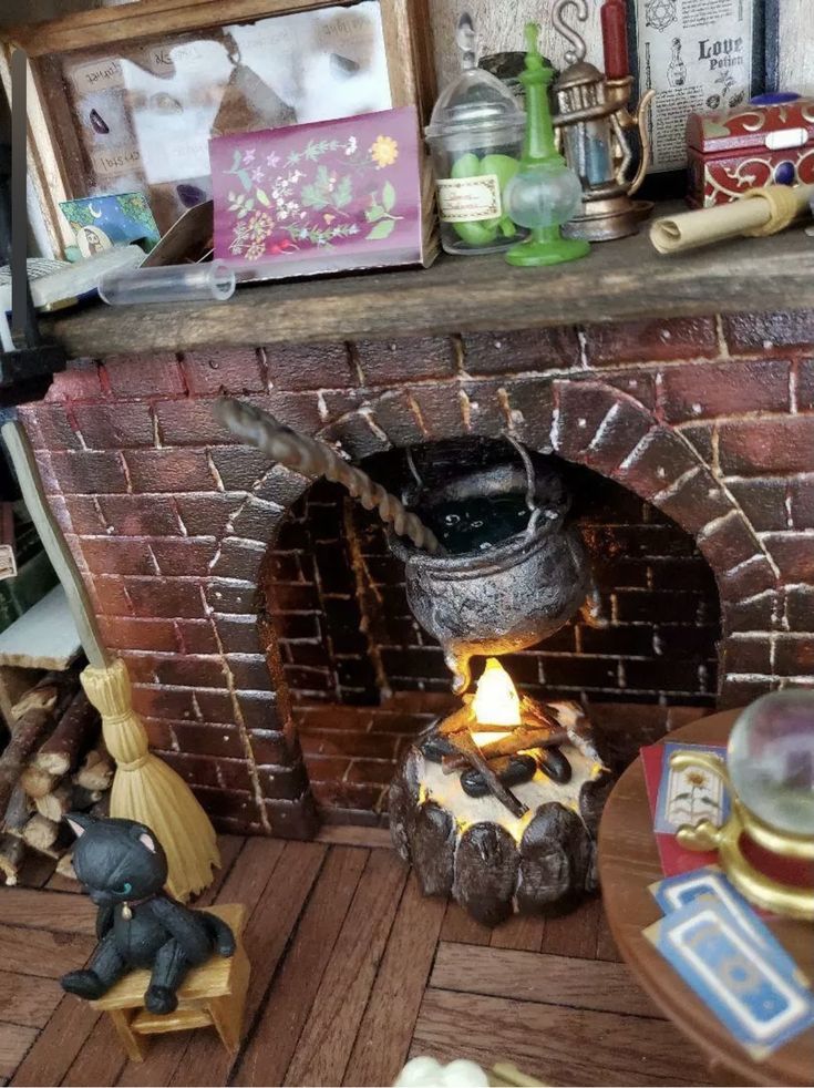 an old brick fireplace with pots and pans on the mantle, next to other figurines