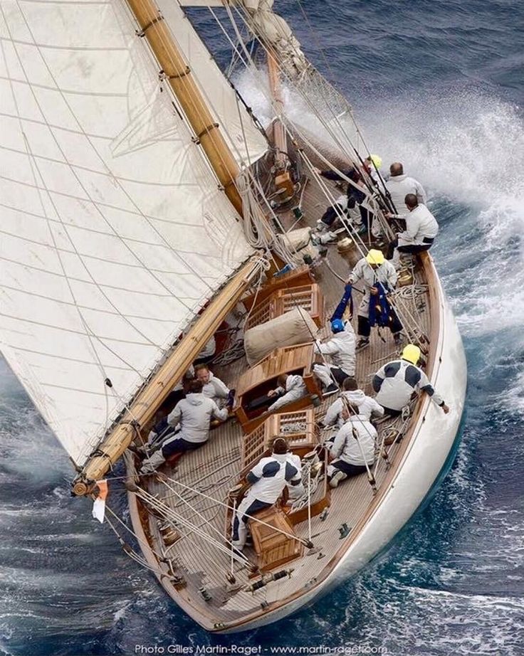 a group of people on a sailboat in the ocean