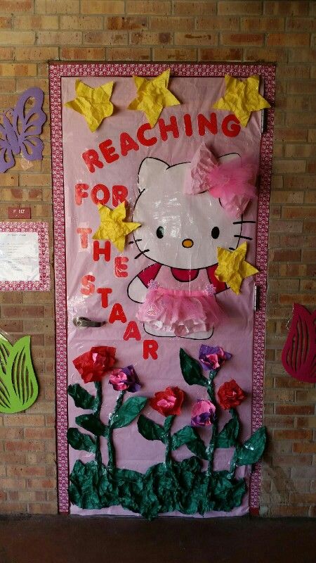 a hello kitty door decorated with flowers and paper machs for the teacher's day