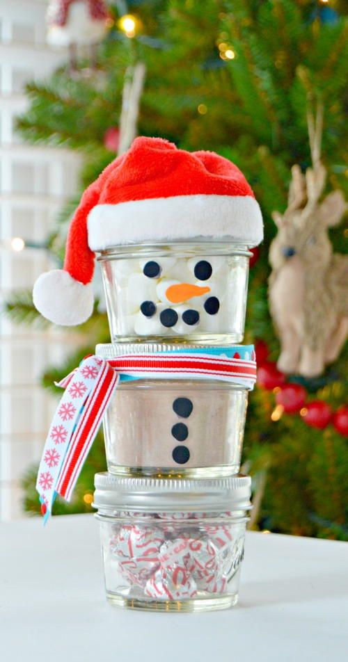 a stack of glass containers with a snowman hat on top