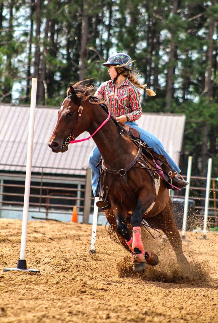 a woman riding on the back of a brown horse