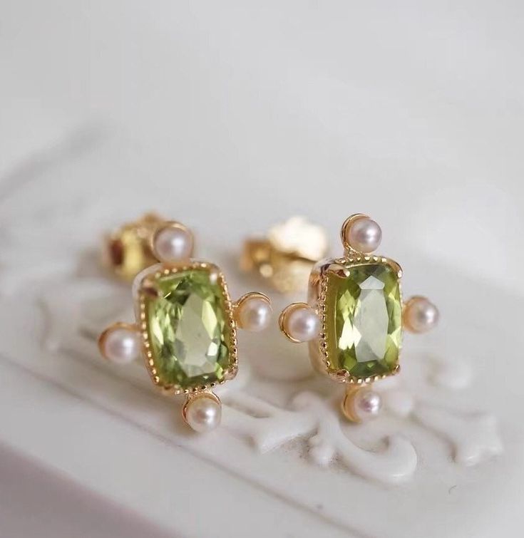 Eliza Peridot Freshwater Pearl Earrings are inspired by my grandmother's earrings from the 1950's. Peridot has fiery origins because it comes from lavas. As a type of olivine, a mineral that nature provides in abundance. We know of only two gemstones that come from lava versus the earth's crust - diamond and peridot! ◊ 18K Gold Vermeil ◊ Natural peridot + Freshwater pearls ◊ Earrings measure approximately 11 x 9 mm ◊ This is a made to order ring, please expect 2-3 weeks to make. Don't worry, we Green Peridot Fine Jewelry, Peridot Gold Earrings, Peridot Gemstone Earrings, Gold Peridot Earrings Fine Jewelry, Classic Green Peridot Earrings, Pearls Earrings, Freshwater Pearl Earrings, Peridot Jewelry, Peridot Earrings