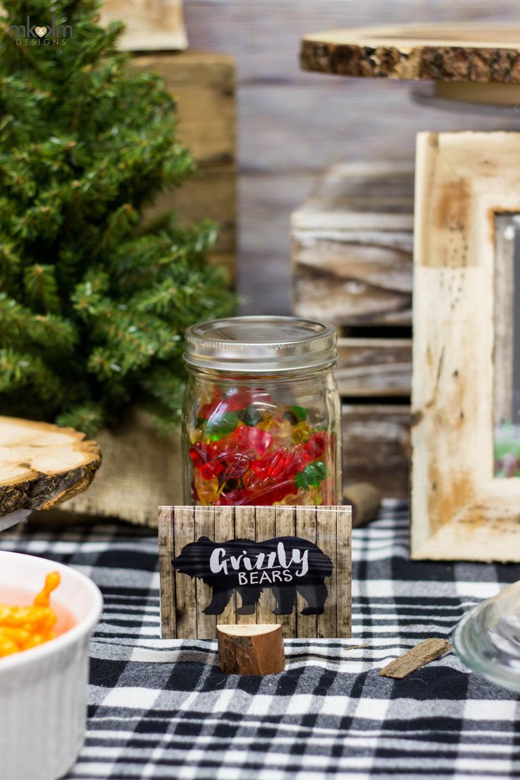 a table topped with a jar filled with gummy bears