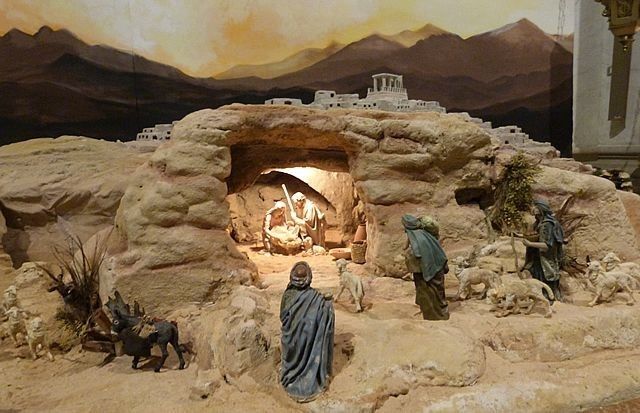 the nativity scene is displayed in front of a painting