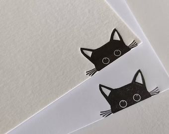 two black cats stickers on white paper