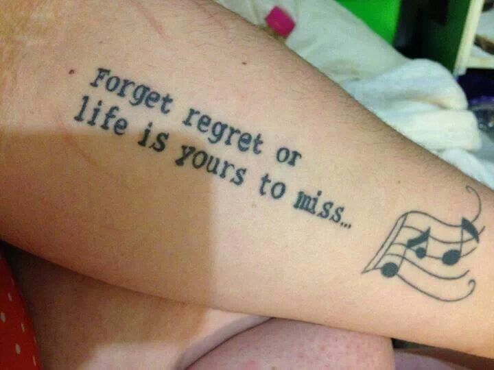 a person with a tattoo on their arm that says forget regret or life is yours to miss