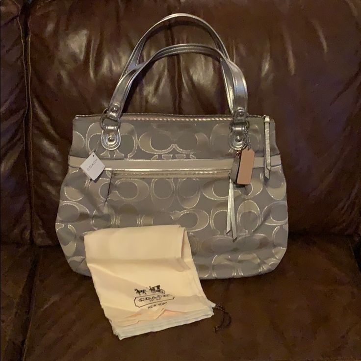 Dove (Gray) And Silver Coach Handbag. Comes With Dust Bag. $198 Original Price Coach Gray Bag With Silver-tone Hardware, Coach Bags With Silver-tone Hardware In Gray, Designer Silver Tote Bag, Silver Coach Shoulder Bag With Handles, Silver Double Handle Shoulder Bag, Coach Gray Shoulder Bag With Silver-tone Hardware, Coach Silver Tote Bag, Silver Coach Tote Bag, Silver Tote Shoulder Bag With Handle Drop