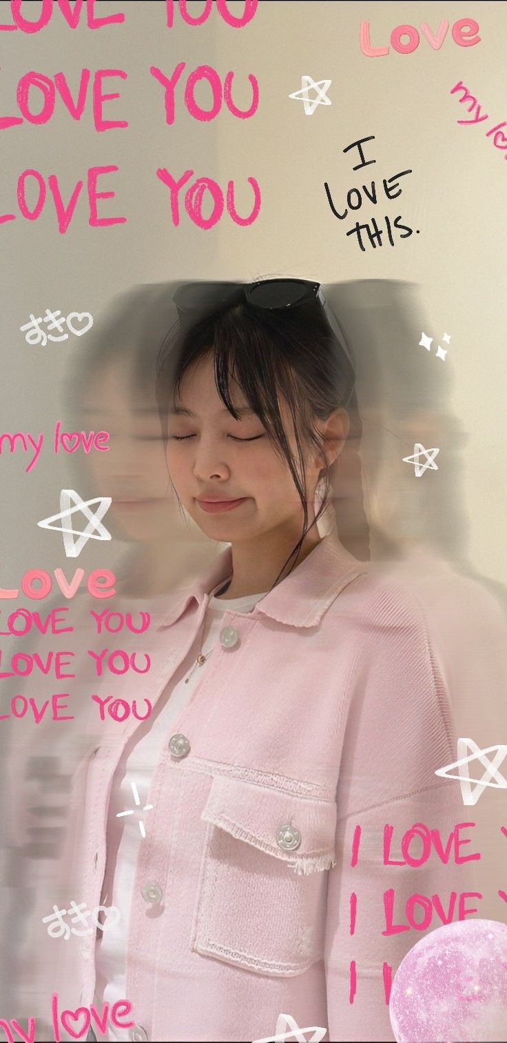 a woman standing in front of a wall with writing on it and an i love you sign behind her