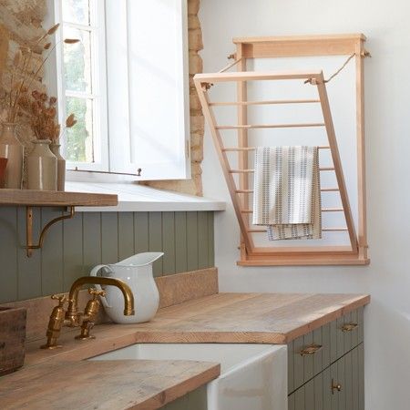 a bathroom with a sink, mirror and towel rack on the window sill above it