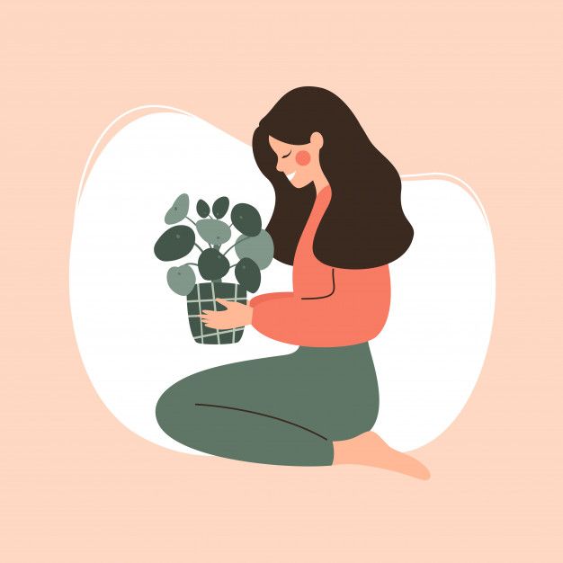 a woman is sitting on the floor holding a potted plant and looking at it