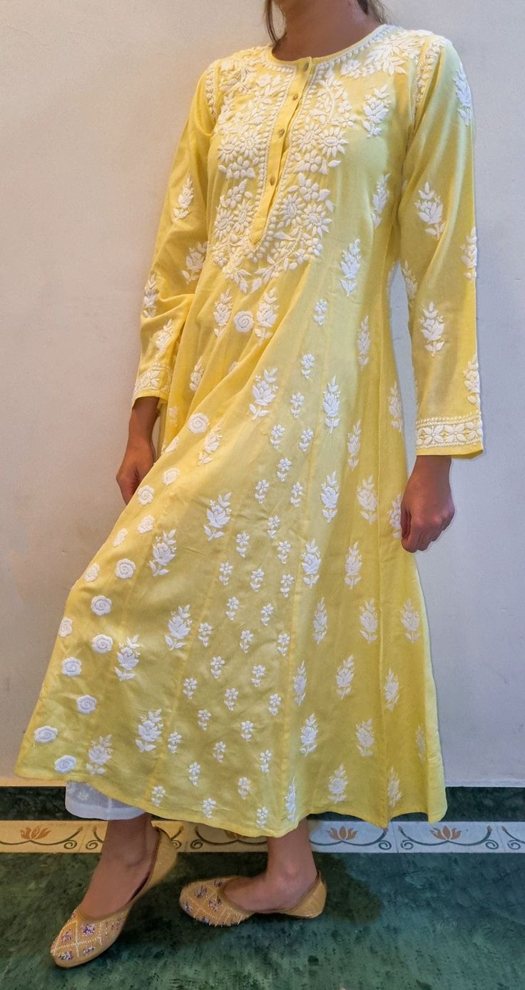 Made from Soft Pure Cotton , the Maharani Dress is Highlighted by Fish Kali panels to give it the voluminous flair The panels are distinguished from each other by different sets of motifs and embroidered intricately in Chikankari throughout the length of the piece. Prewashed. Preshrunk. Bucket wash and line dry and light iron for best results. Length - 48 inches sizes - S - fits bust 34 M - fits bust 36 L - fits bust 38 XL - fits bust 40 0X - fits bust 42 1X - fits bust 44 Anaar Kali Dress, Navratri Embroidered Straight Kurta Dress, Anarkali Tunic Dress With Intricate Embroidery, Resham Embroidered Maxi Dress For Navratri, Spring Festive Kurta With Motifs, Festival Tunic Dresses With Resham Embroidery, Navratri Long Sleeve Dress With Intricate Embroidery, Long Sleeve Dresses With Intricate Embroidery For Navratri, Traditional Floor-length Dress With Chikankari Embroidery