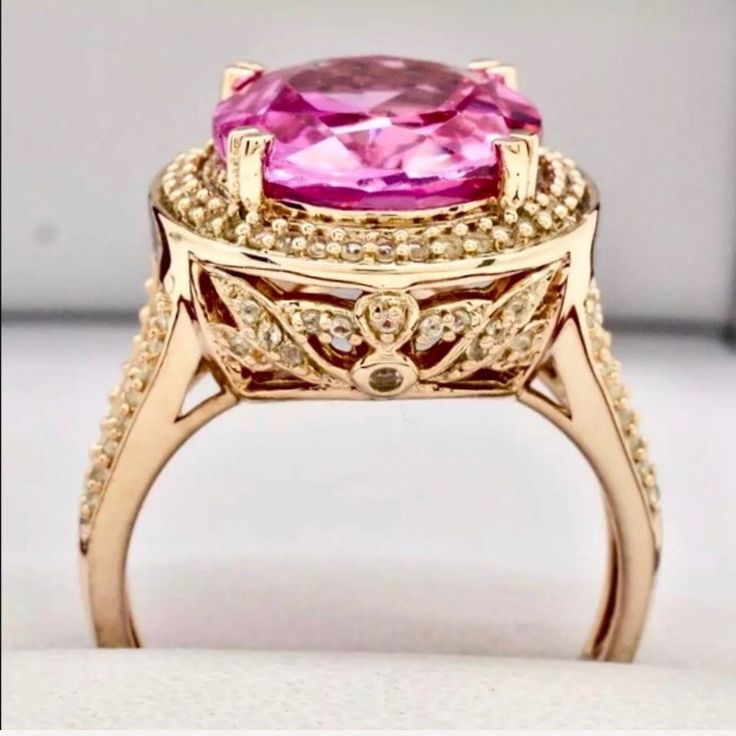 Out Of This World Vivid Pinkovaltopaz Ring Main Stone Carat Weight: 8.21ctw Type: Vivid Pink Topaz-Lab Created Shape: Oval Cut Color: Pink Clarity: Vs Accent Stones: White Topaz Accent Carat Weight: .01ctw Shapes: Round Color: White Clarity: Vvs More Details Total Carat Weight: 9.00ctw North To South: 18.4mm Height Above Finger: 10.2mm Shank Width: 2mm Finger Size: 8 Gram Weight: 7.5g Material: 14k Rose Gold Over 925 Sterling Silver *Retail Value: $499 Luxury Pink Topaz Ring With Diamond, Pink Sapphire Ring With Halo Design For Formal Occasion, Formal Pink Sapphire Ring With Halo Design, Exquisite Pink Rings With Diamond Accents, Oval Pink Sapphire Diamond Ring With Accents, Pink Topaz Ring With Halo Setting As Gift, Luxury Pink Topaz Ring, Oval Pink Sapphire Jewelry With Diamond Accents, Pink Oval Diamond Ring With Accent Stones