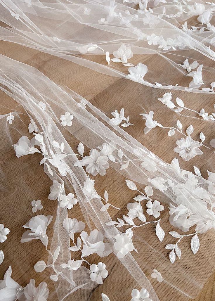 wedding veils with flowers and leaves on a wooden table