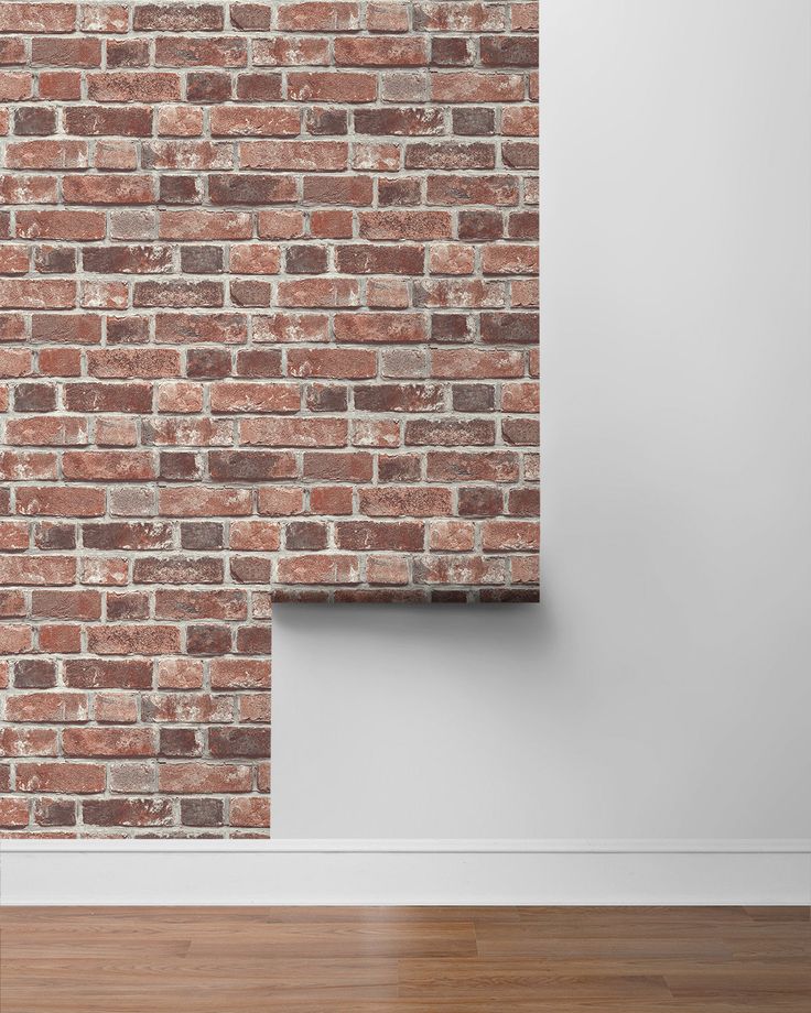 an empty room with a brick wall and wooden floor