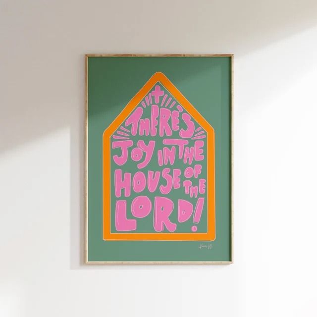 a painting on the wall with words written in pink and green, against a white background