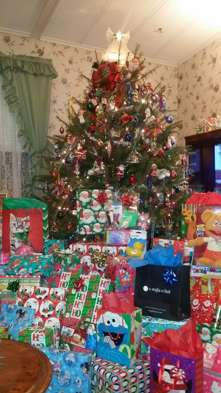 a christmas tree is surrounded by presents